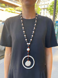 A long antique ivory, onyx and coral necklace
